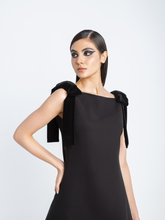 Close-up of velvet bow detail on black crepe cocktail dress – Fara