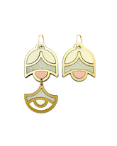 Close-up of handmade asymmetrical earrings in blush and gold tones on white background