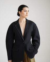 model wearing black linen blend blazer with decorative stitches