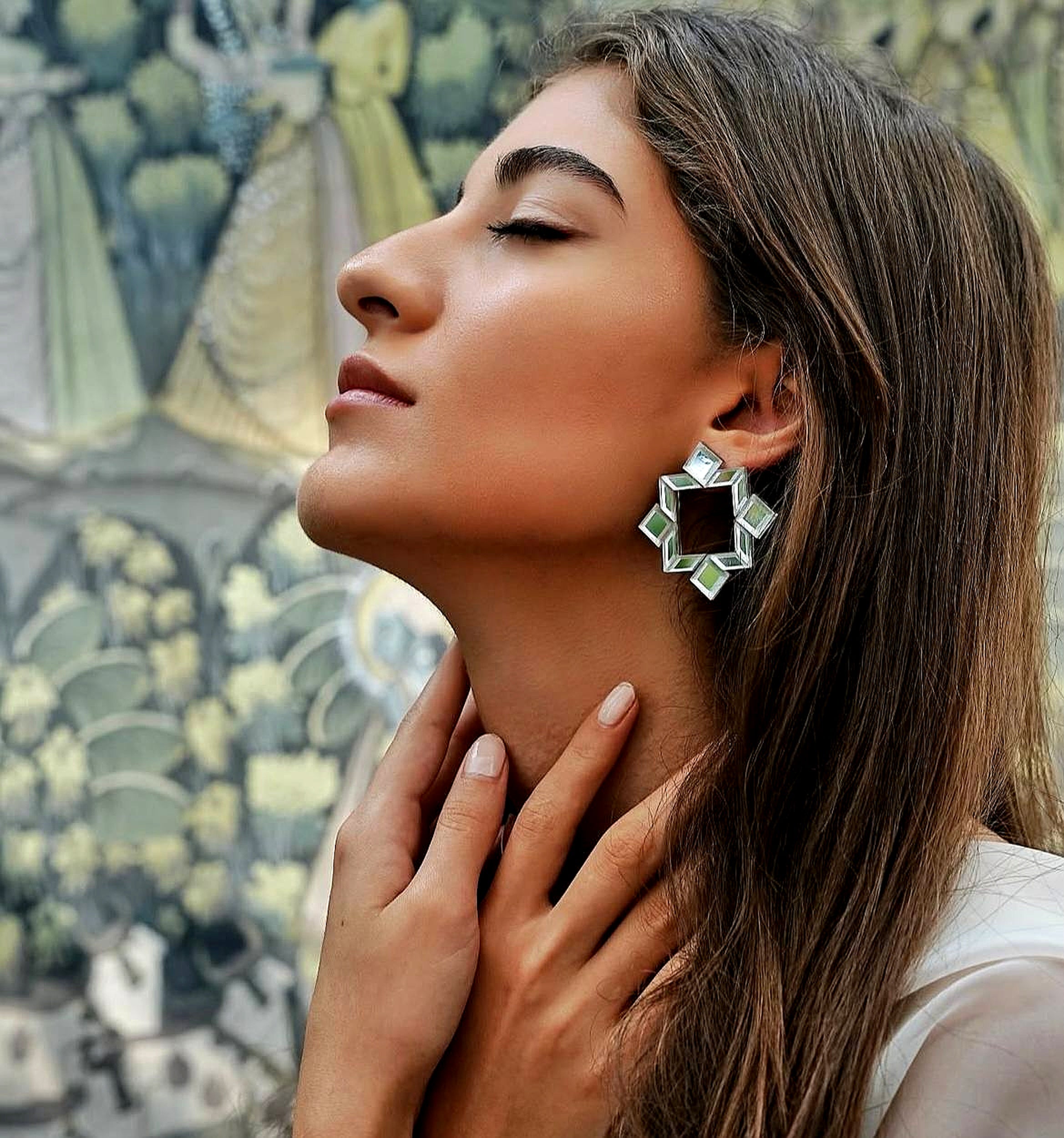Model wearing handmade geometric mirror earrings inspired by Persian architecture
