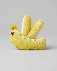 Corn sculpture shaped like a bird with a crown on a gray background