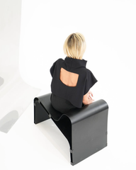 Black backless blouse with high neck and wide cap sleeves, rear view