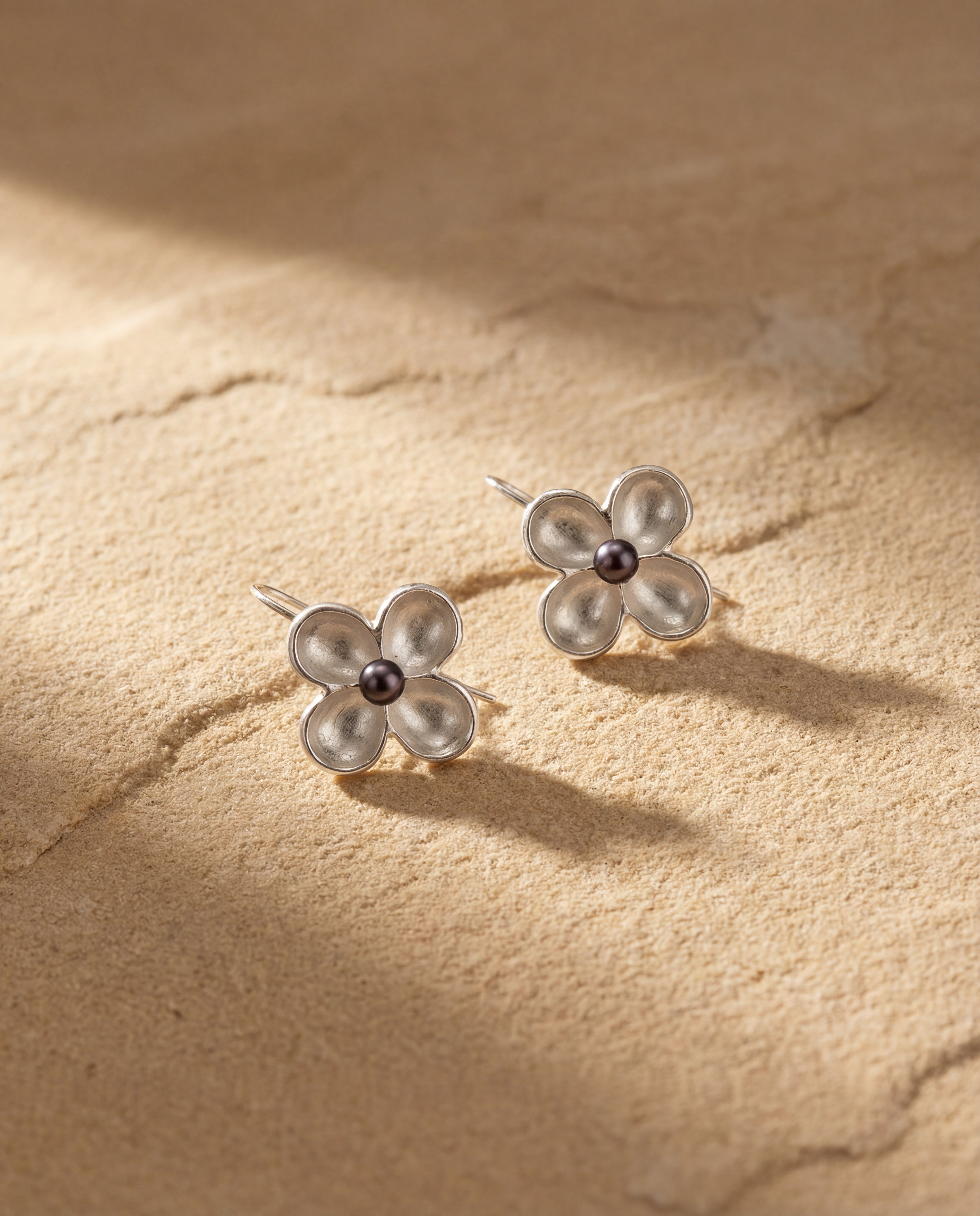 Artisan sterling silver earrings with dark pearl detail