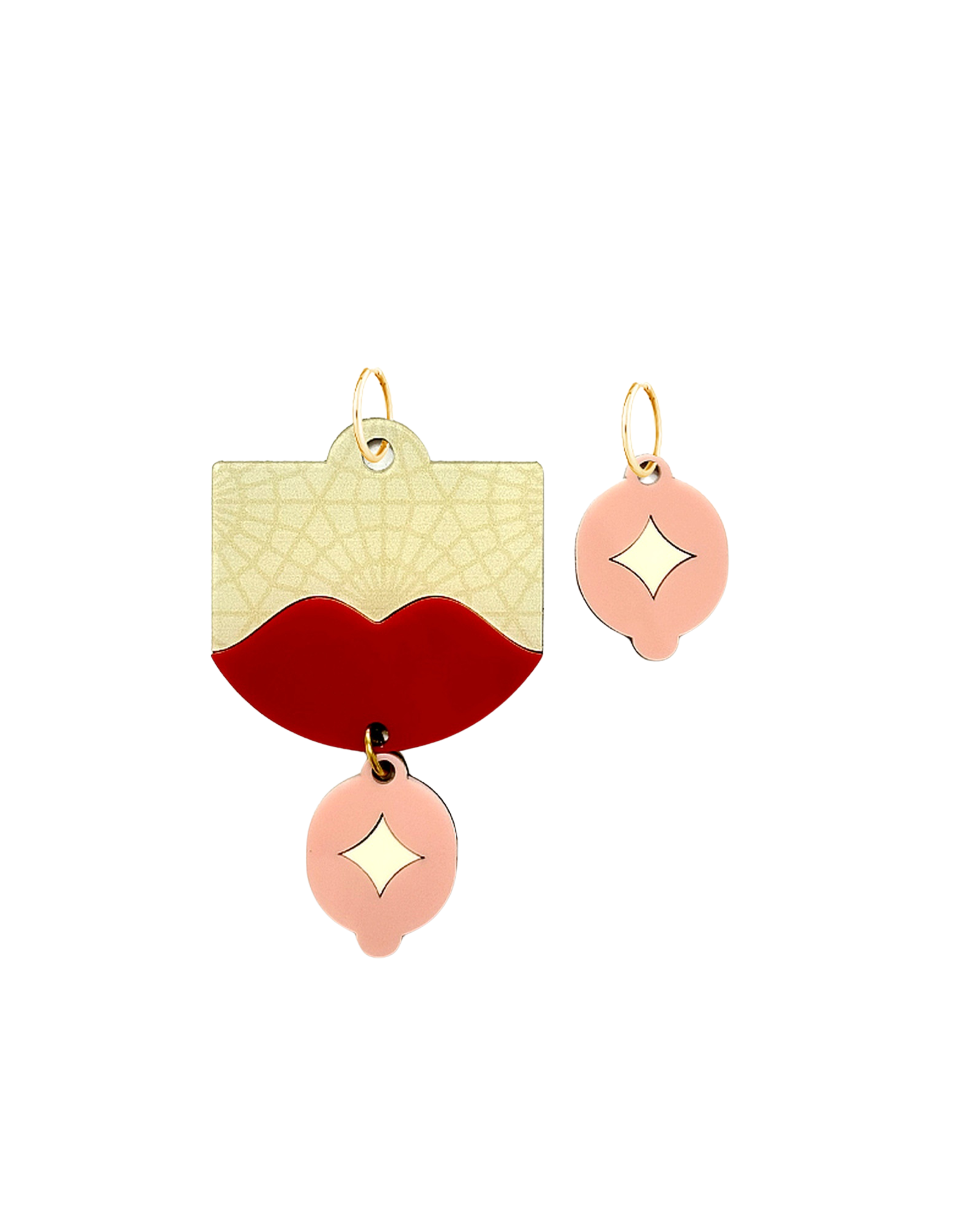 Handmade mismatched earrings with red lips and pink charm displayed on white background