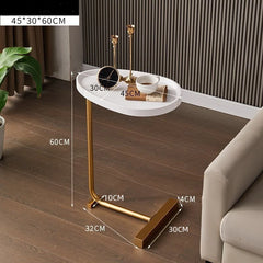 Small round table with gold legs on a wooden floor, dimensions labeled.
