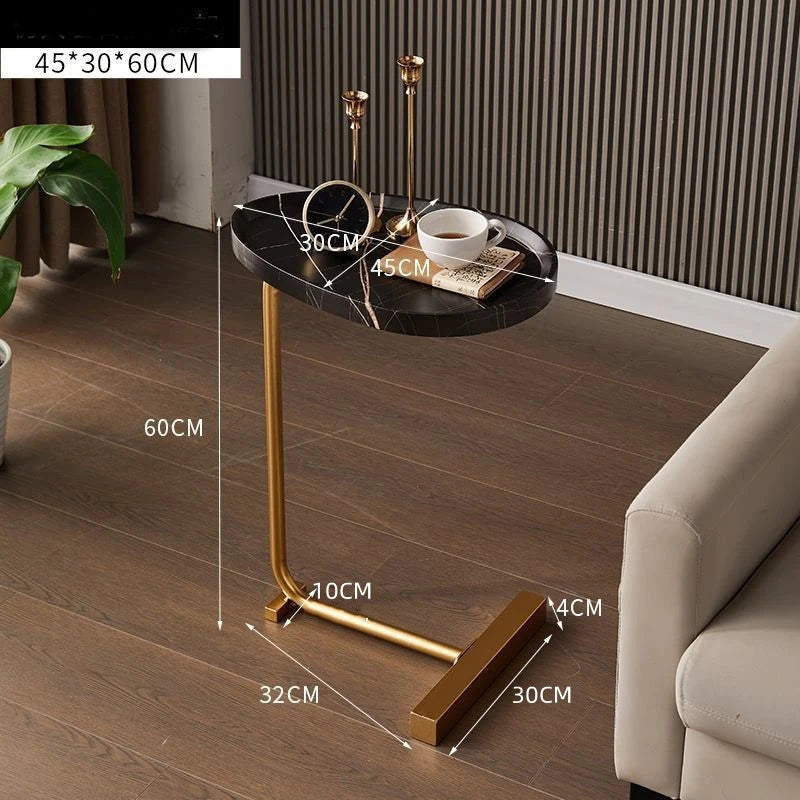 Small round table with gold legs in a living room setting, showing dimensions.