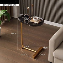 Small round table with gold legs in a living room setting, showing dimensions.