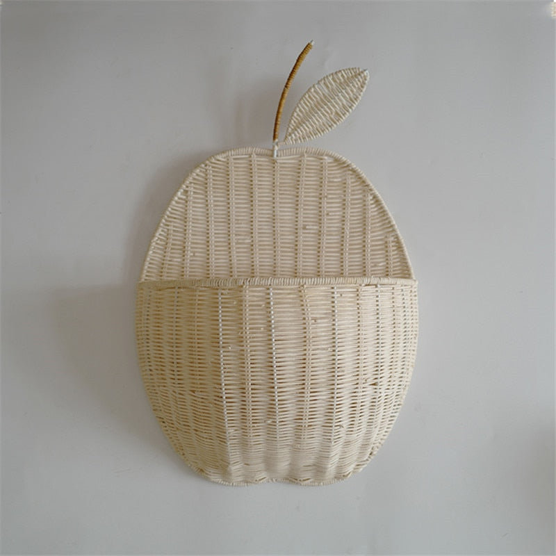 Pear-shaped wicker basket holding baby toy and flowers