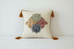 hand printed cotton cushion with tassels on bed