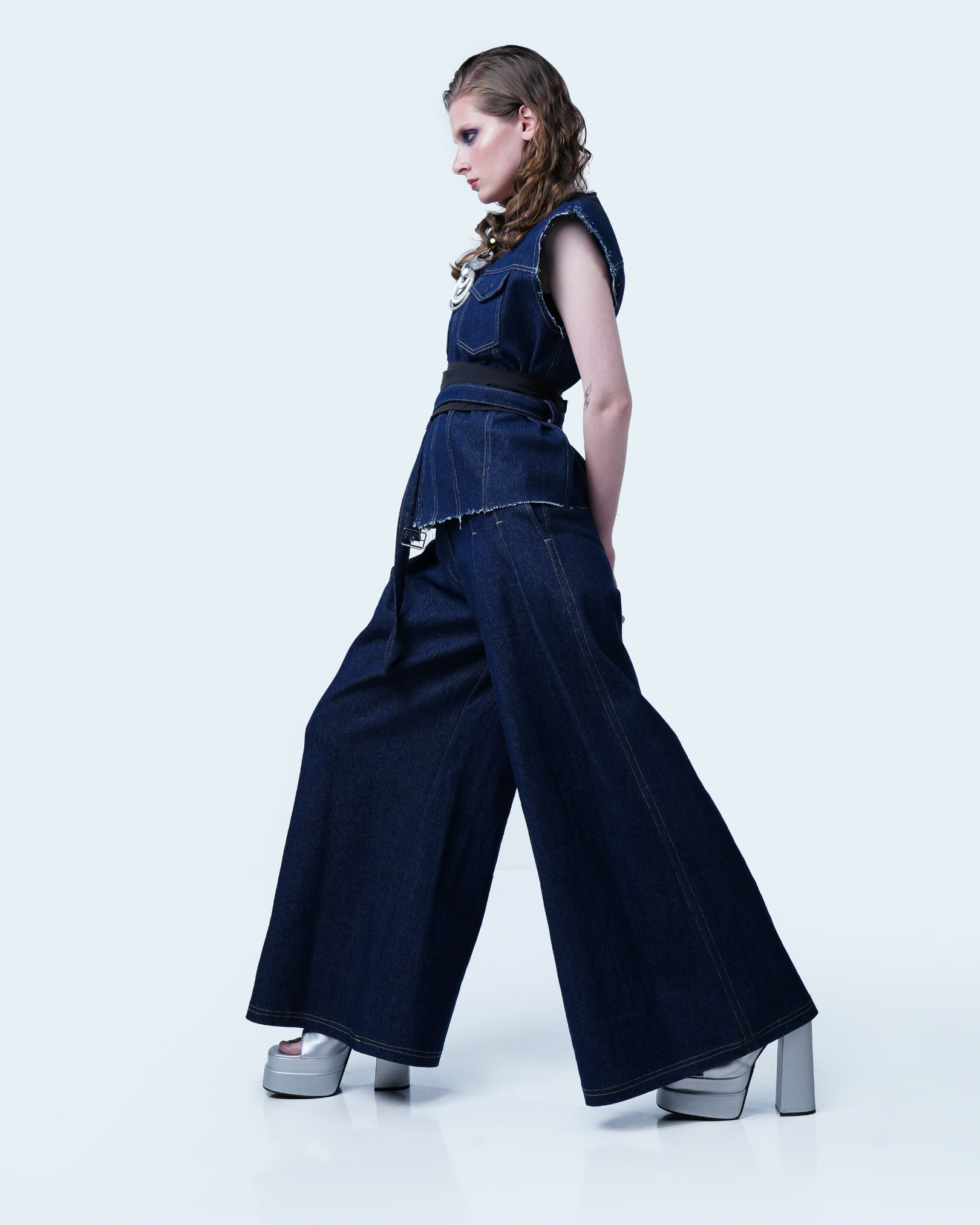 Women’s statement denim vest styled with wide-leg pants