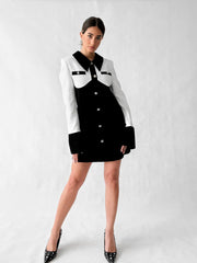 Front view of black and white cocktail dress with tailored fit