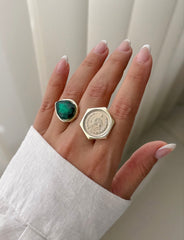 Gold coin ring styled with gemstone ring