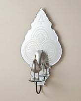 Ornate wall mirror shelf mounted on neutral wall