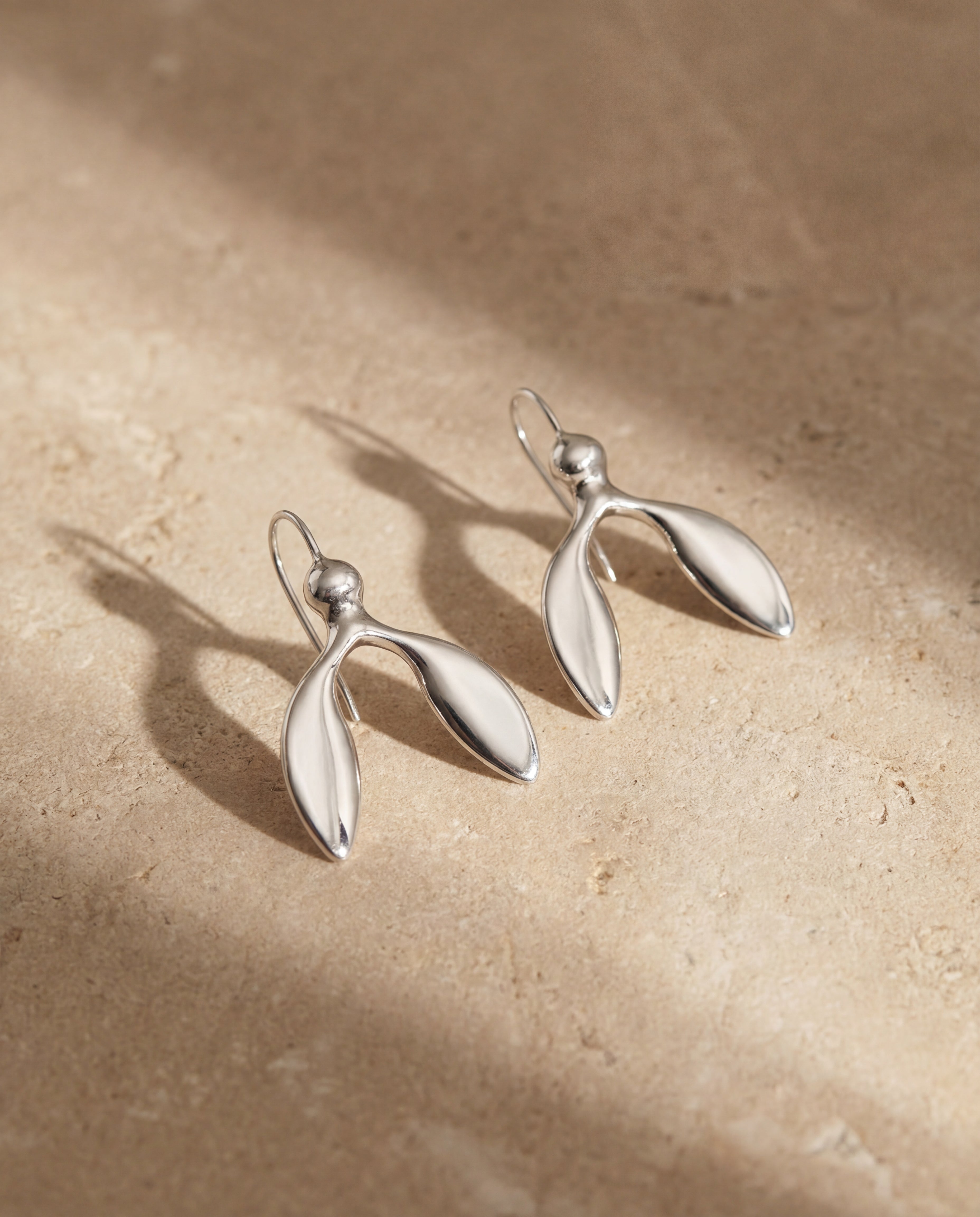 Handmade minimalist silver dangle earrings close up