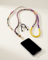 Handmade crossbody phone strap with colorful fabric and charm