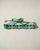 handmade navy and green jacquard tassel belt flat lay