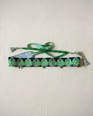 handmade navy and green jacquard tassel belt flat lay