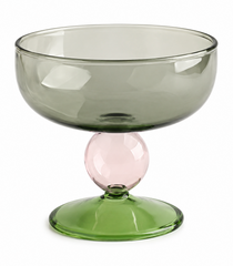 Green glass bowl with a pink accent on a white background