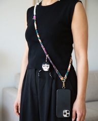 Boho crossbody phone strap worn over black dress