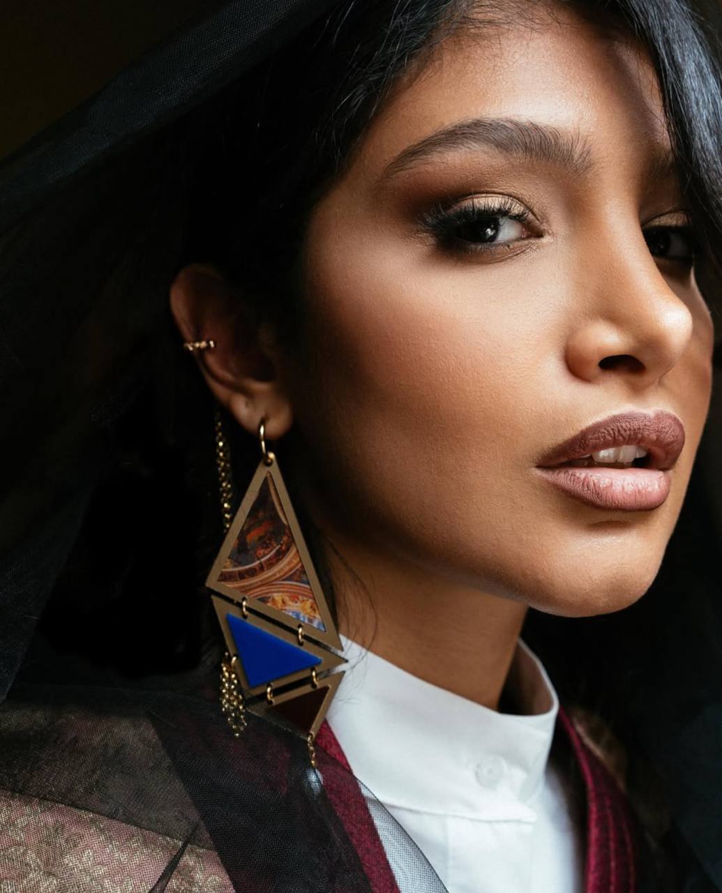 Model wearing handmade triangle earrings with semi precious stone