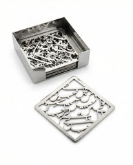 Set of metal coasters with intricate designs in a box on a white background