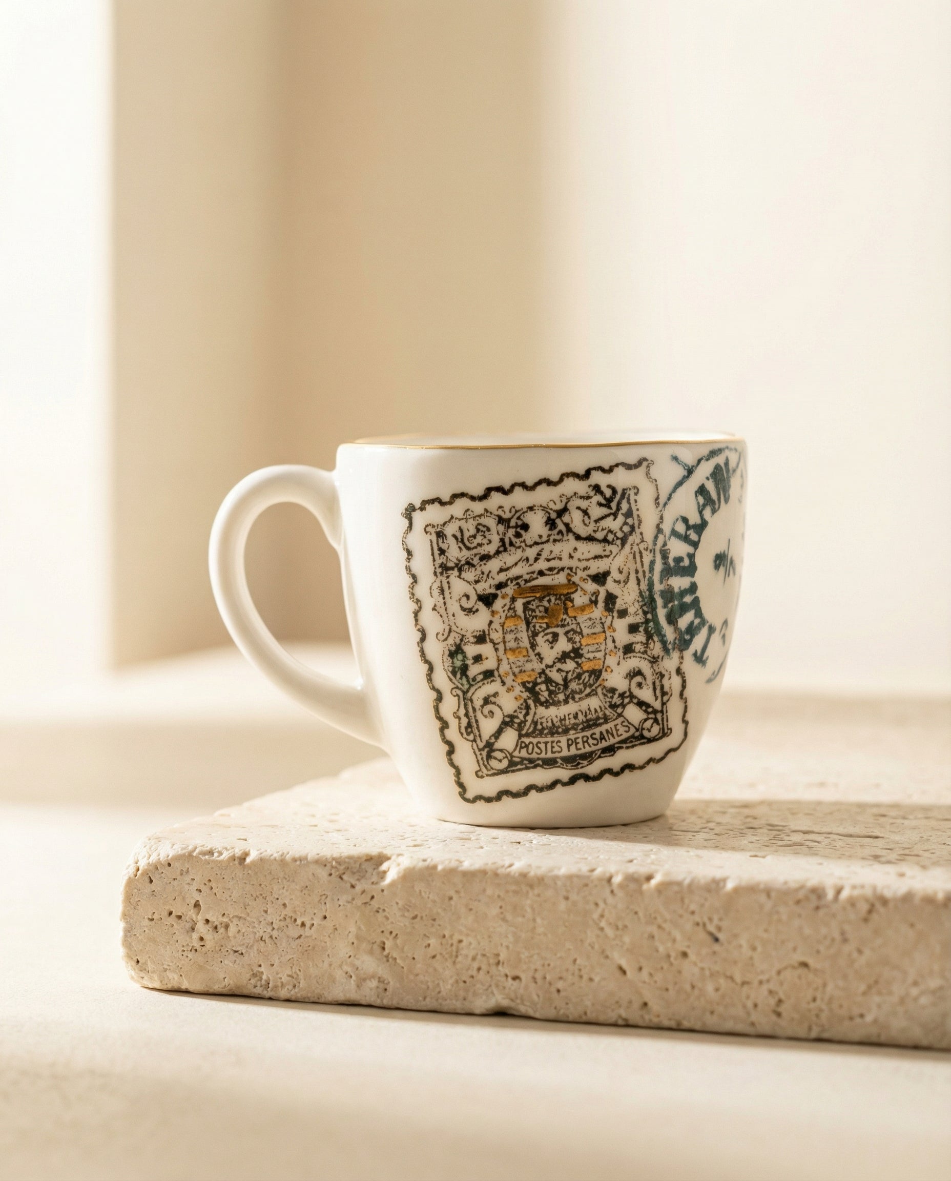 White mug with decorative black and blue design on a light surface