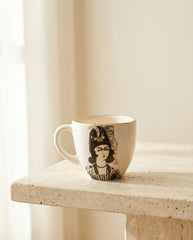 Ceramic mug with artistic design on a light surface