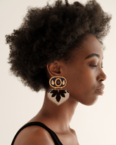 Model wearing handmade lightweight statement earrings in black and gold