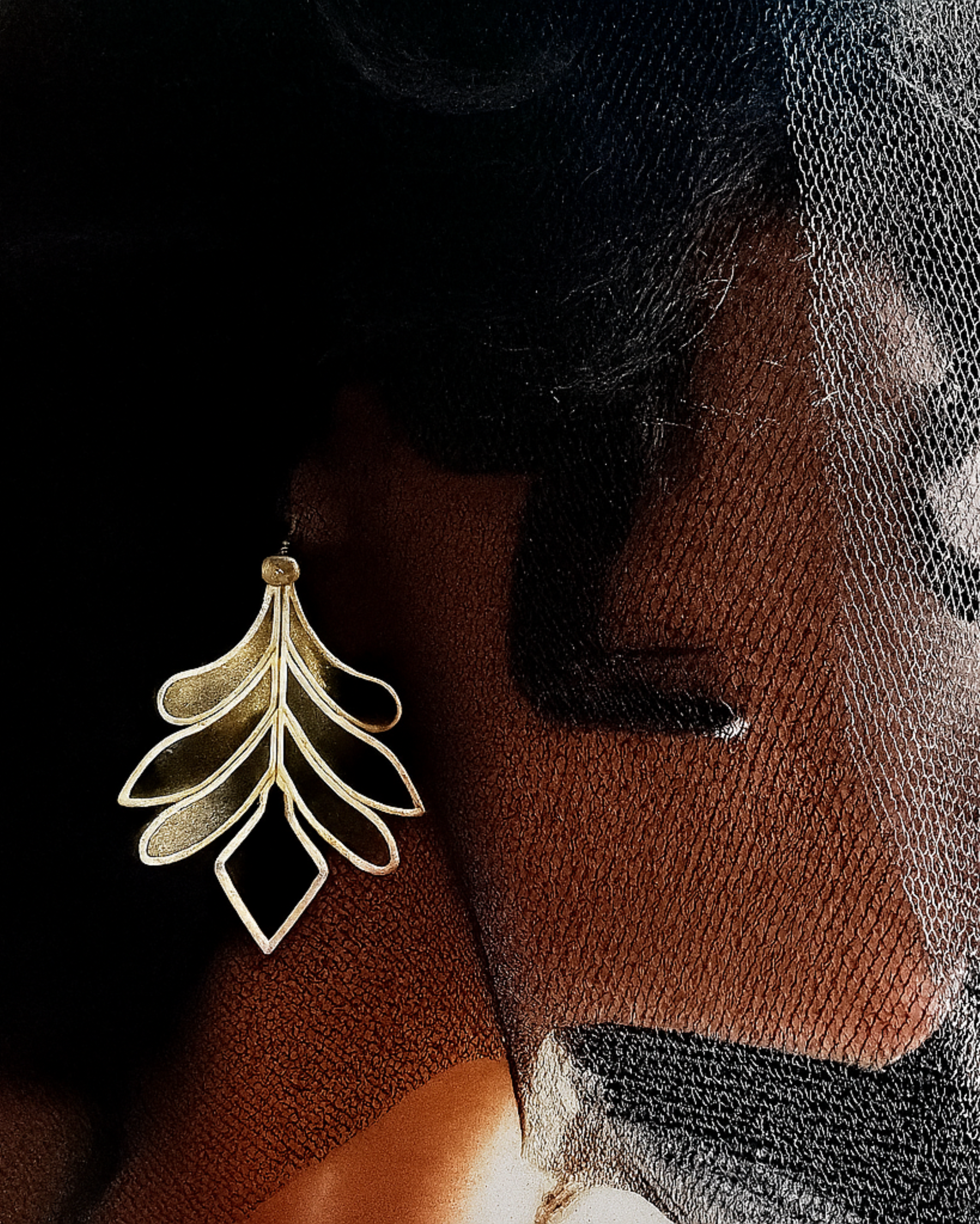 Silver-toned leaf earrings crafted from plexiglass with sculptural design