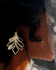Silver-toned leaf earrings crafted from plexiglass with sculptural design