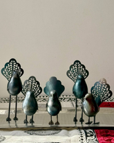 Whimsical handcrafted metal bird with artistic feather detail. A standalone piece that elevates trays, shelves, and curated home corners.