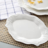 Elegant irregular white ceramic plate in Japanese style. Perfect for dim sum, modern dining, and minimalist table settings at home or events.