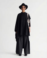 Black sculptural cape front full length view