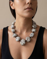 Handmade paper mache statement necklace on model