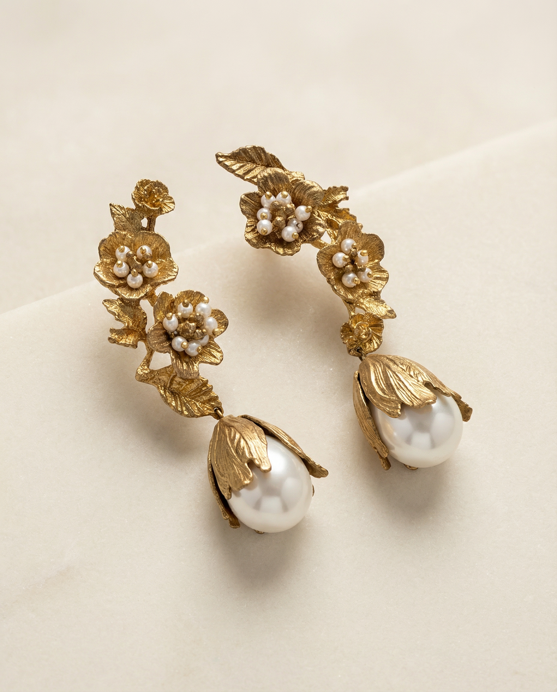 Floral gold tone brass earrings close up detail