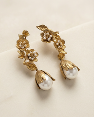 Floral gold tone brass earrings close up detail