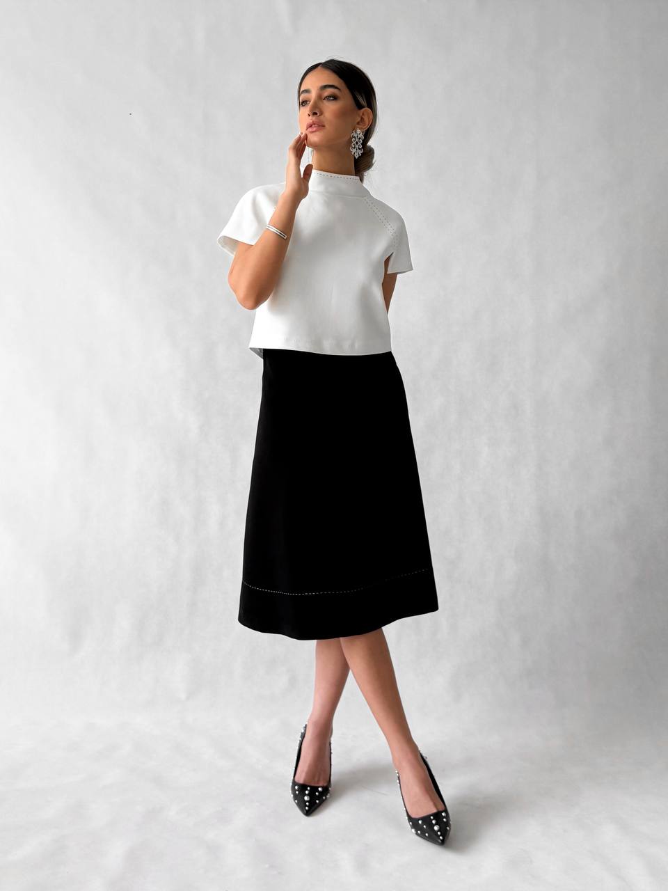 Black crepe A-line skirt with stitched hem