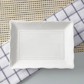 White ceramic rectangular dish on a checkered cloth