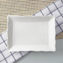 White ceramic rectangular dish on a checkered cloth