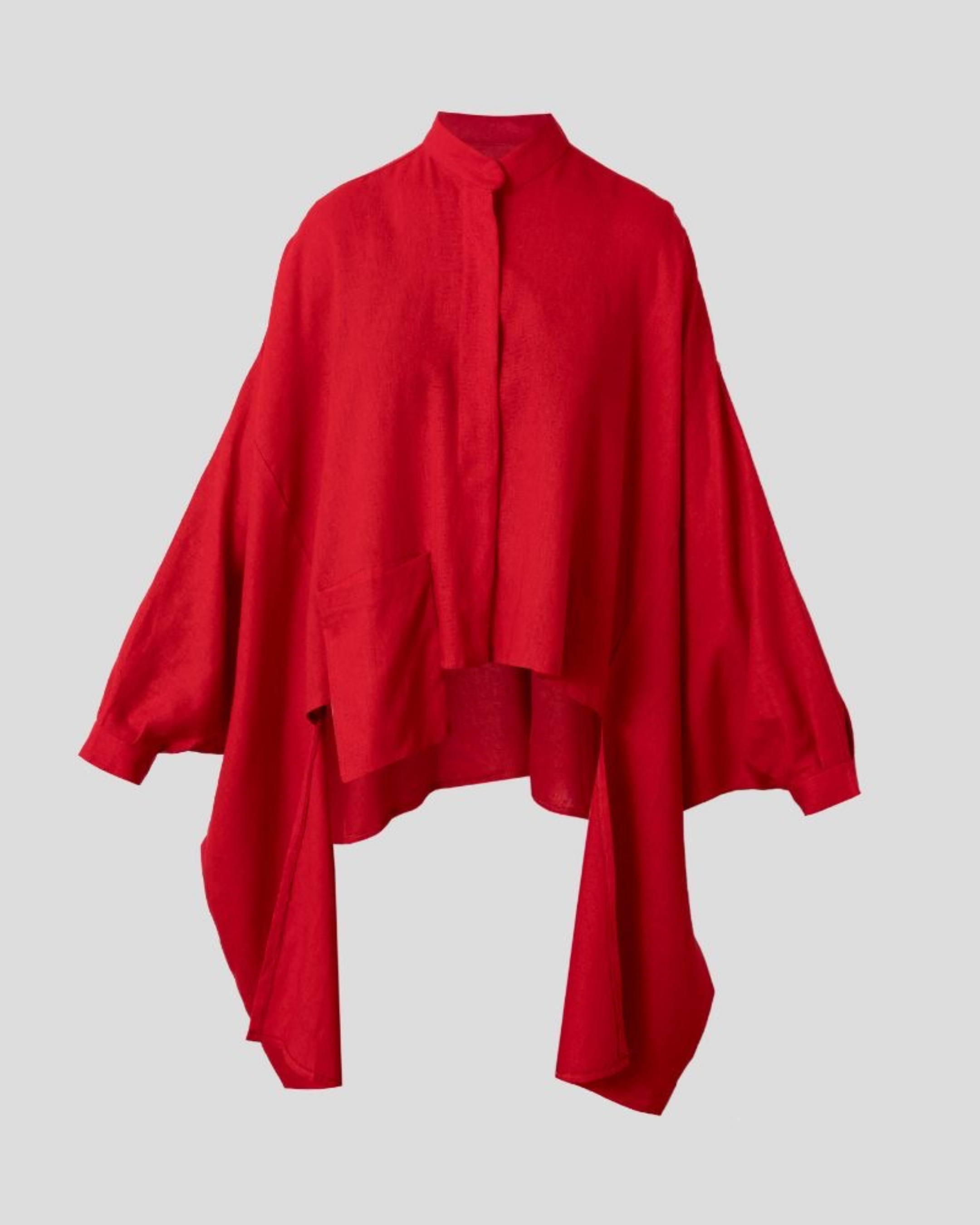 Red blouse with a high collar on a light gray background