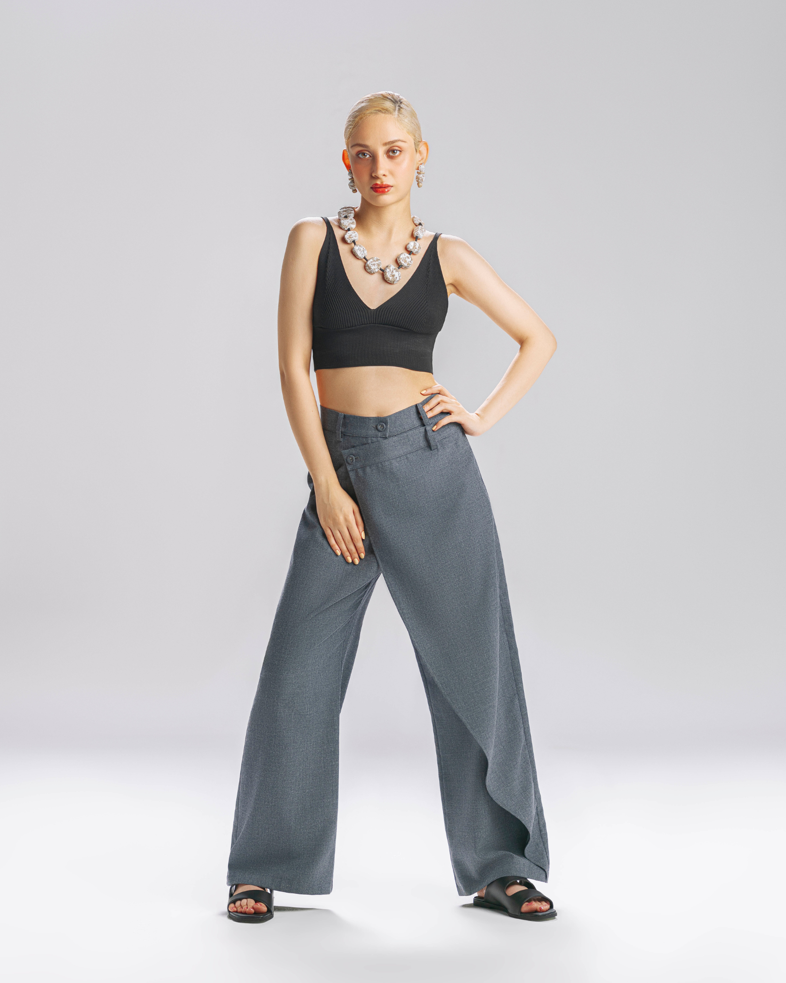Wide leg tailored grey trousers on model
