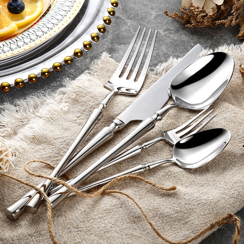 modern stainless steel cutlery set on white plate