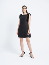 Model wearing black cocktail dress with velvet shoulder bows – Fara