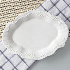 White decorative plate on a checkered cloth