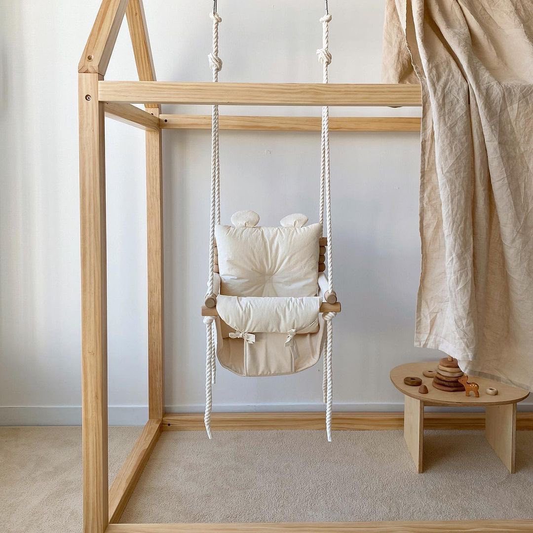 Wooden baby swing with fabric seat and cotton ropes