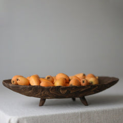 Handcrafted retro wooden fruit tray on linen tablecloth