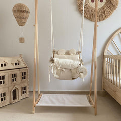 Indoor baby swing hanging in neutral Scandinavian nursery