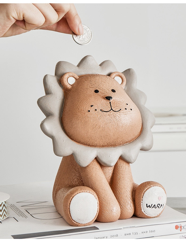 Hand placing coin in lion piggy bank