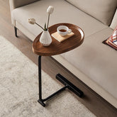 modern oval wood and metal coffee table next to sofa