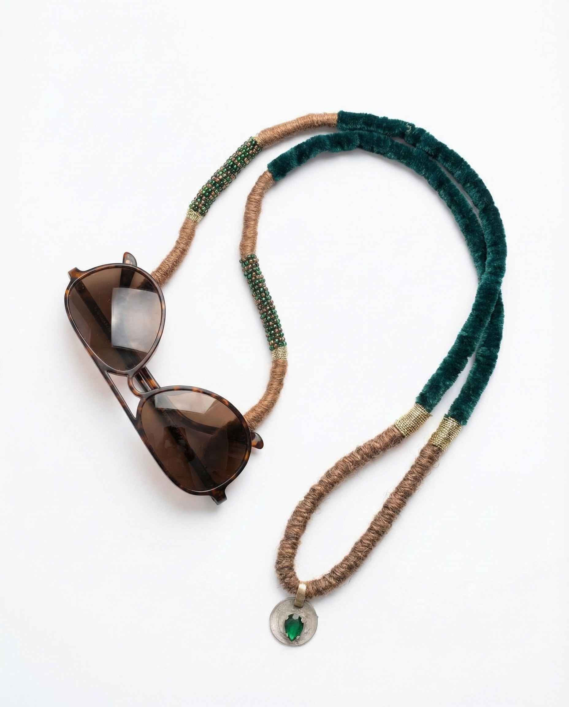 Sunglasses on a colorful beaded eyeglass holder against a white background